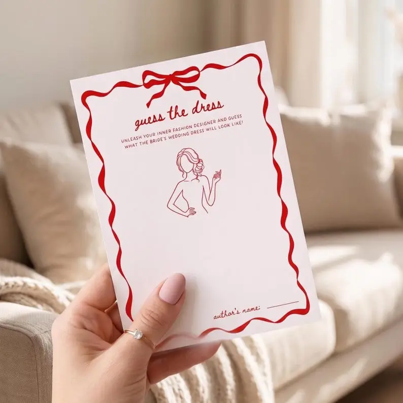 Guess The Dress game card in blush with a red wavy ribbon border and bow, showing a line-drawn figure holding a glass with blank space to sketch a dress and a name line at the foot
