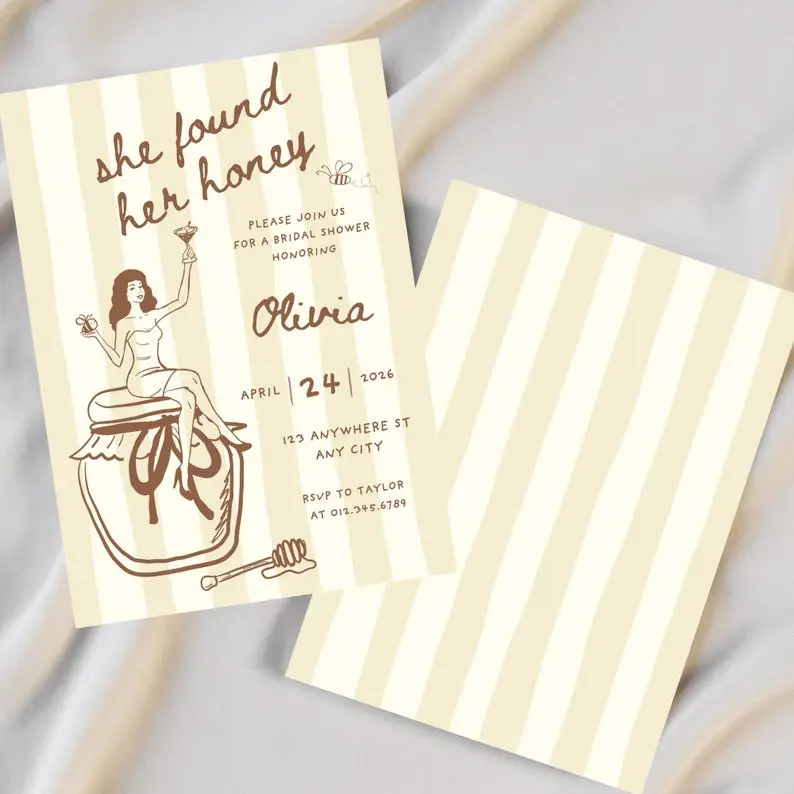 She Found Her Honey bridal shower invitation on a butter yellow striped card in brown ink, with a hand-drawn woman in a slip seated on a honey jar raising a martini, a bee and a honey dipper