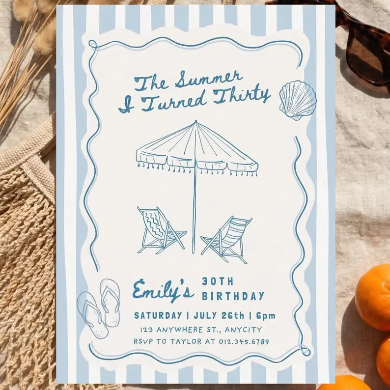 The Summer I Turned Thirty birthday invitation on a blue and white striped card in matching blue ink, with a hand-drawn fringed beach umbrella, deck chairs, a scallop shell and flip flops inside a wavy frame