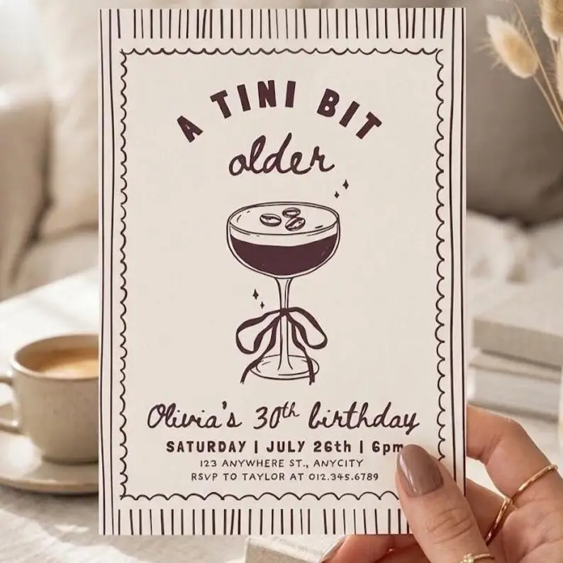 Tini Bit Older espresso martini birthday invitation in cocoa and cream with a scalloped stamp border and a single ribboned martini coupe illustration