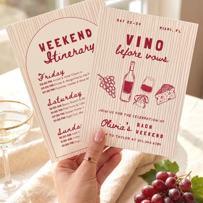 Vino Before Vows bachelorette invitation in deep red on a cream pinstriped card, with hand-drawn grapes, a wine bottle, a glass tied with a bow and a wedge of cheese, beside an arched weekend itinerary card